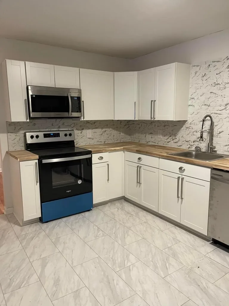 A white shaker kitchen with a freestanding electric range