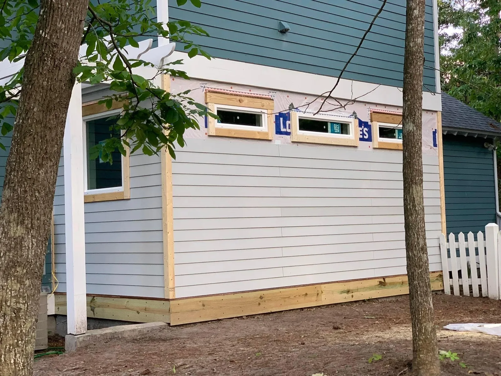 An outbuilding finished with new lap siding and windows